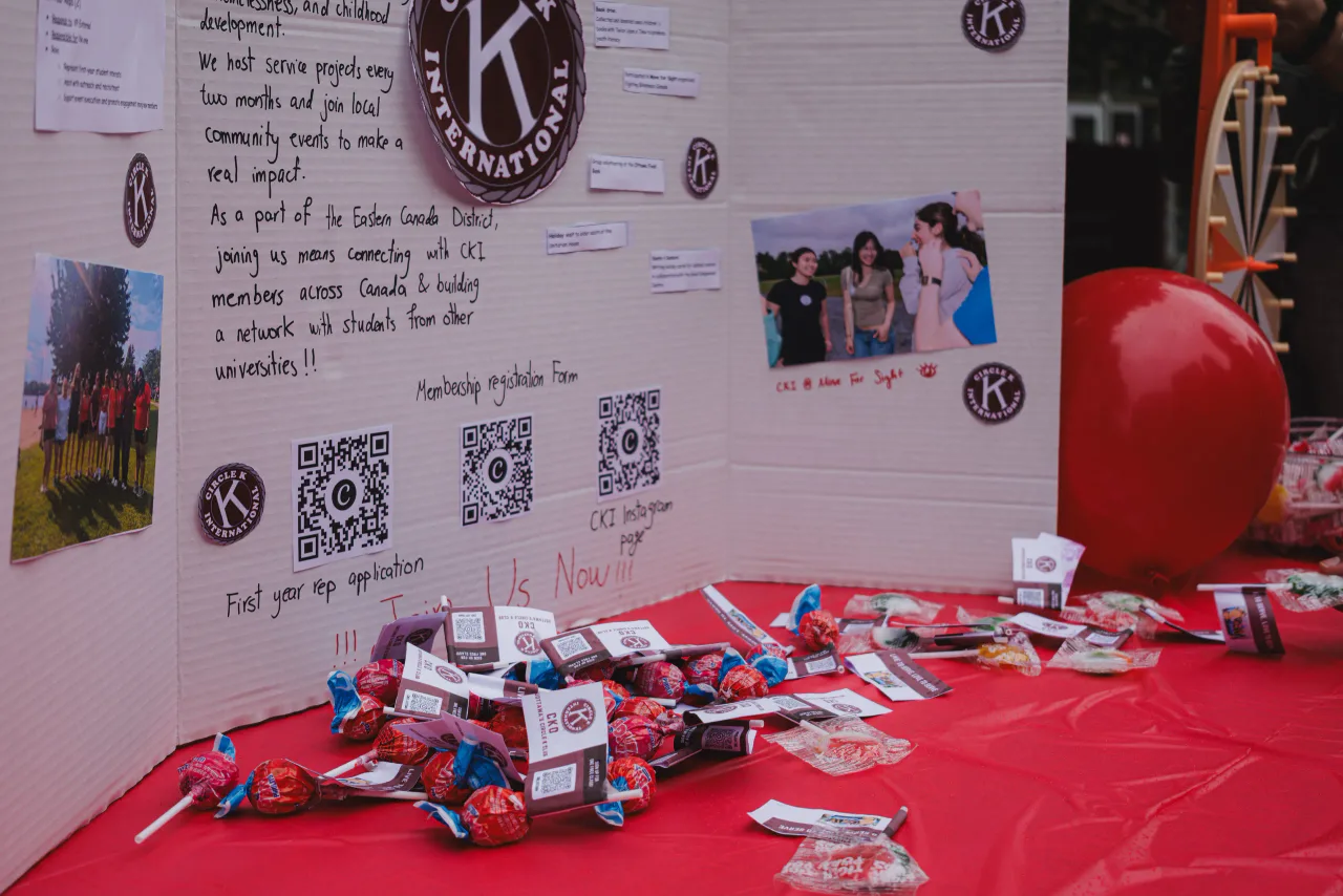 The club's poster board, covered in QR codes and photos from past events